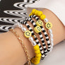 6 beaded bracelets set with polymer smiley face