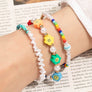 Smiley face and pearl layered bracelet