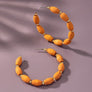 Spindle shape wood beaded hoop earrings