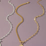 asymmetric chain necklace with coin pendant