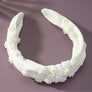 Knotted fabric headband with daisy decor