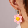 Huggie hoop dangling flower smiley face earrings