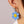 Huggie hoop dangling flower smiley face earrings