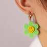 Huggie hoop dangling flower smiley face earrings