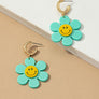 Huggie hoop dangling flower smiley face earrings