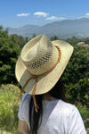 Cowboy  hat in handwoven  straw with a peekaboo pa